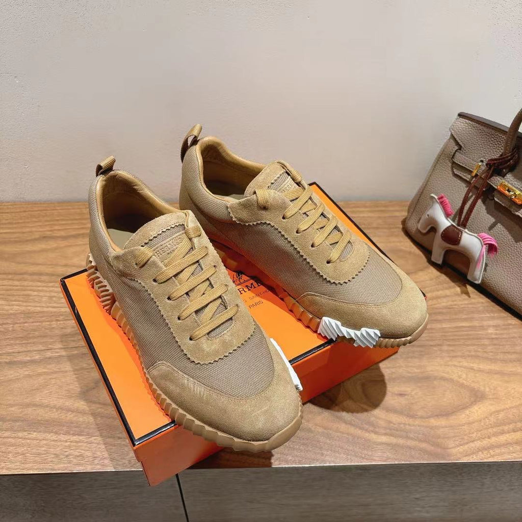 Pair of beige lace-up sneakers with scalloped side detailing and chunky sole