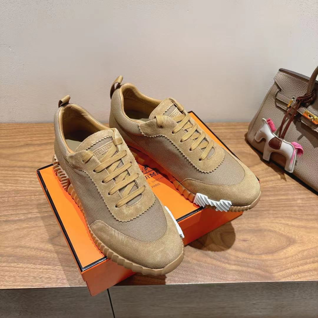 Pair of beige lace-up sneakers with scalloped side detailing and chunky sole