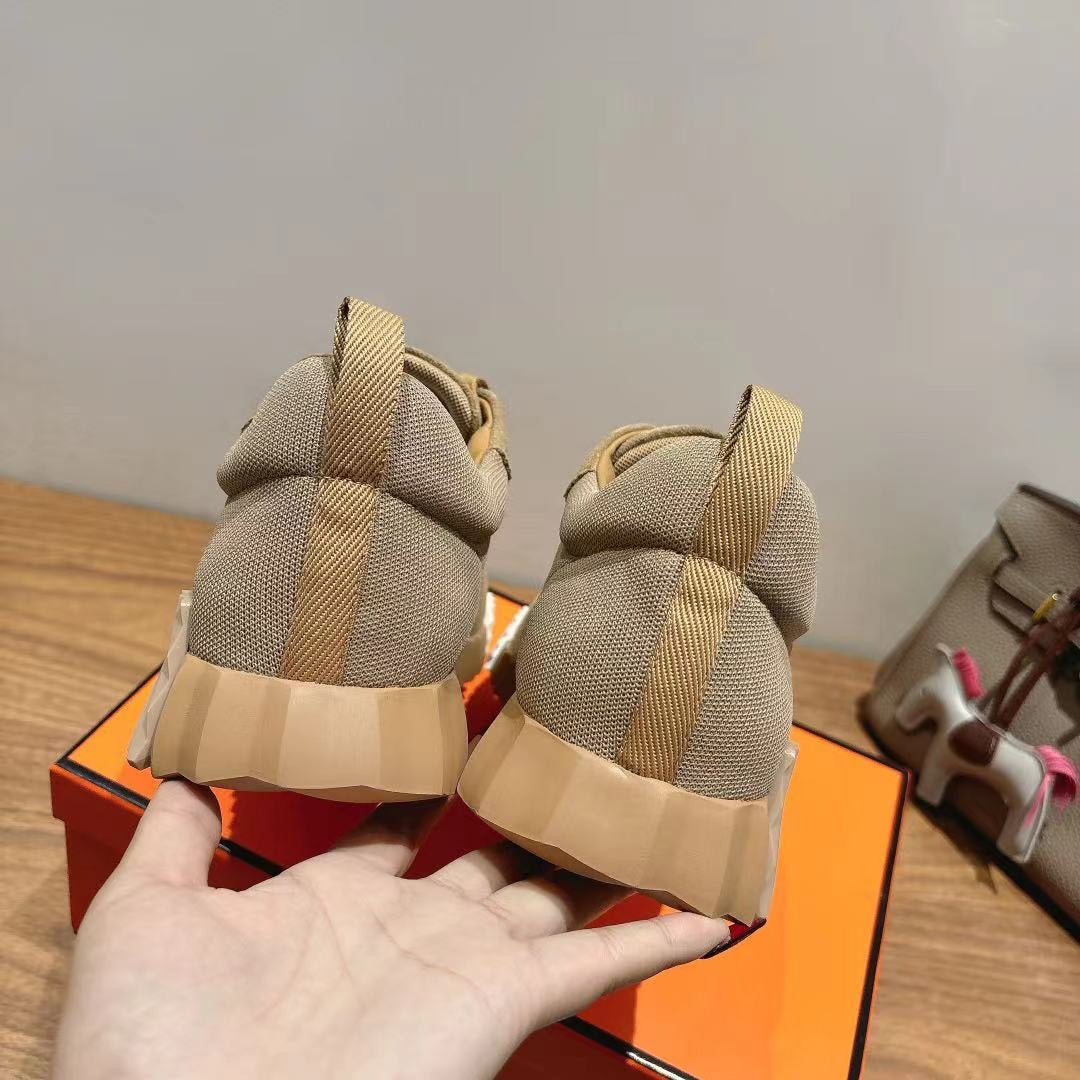 Beige sneakers heel view with suede uppers, fabric panels, and stacked sole