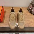 Beige lace-up sneakers with suede panels and ribbed sole tread