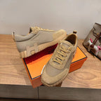 Beige lace-up sneakers with rugged ridged sole and suede toe cap