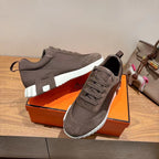 Grey suede lace-up sneakers with white ribbed midsole and cushioned collar, Hermes