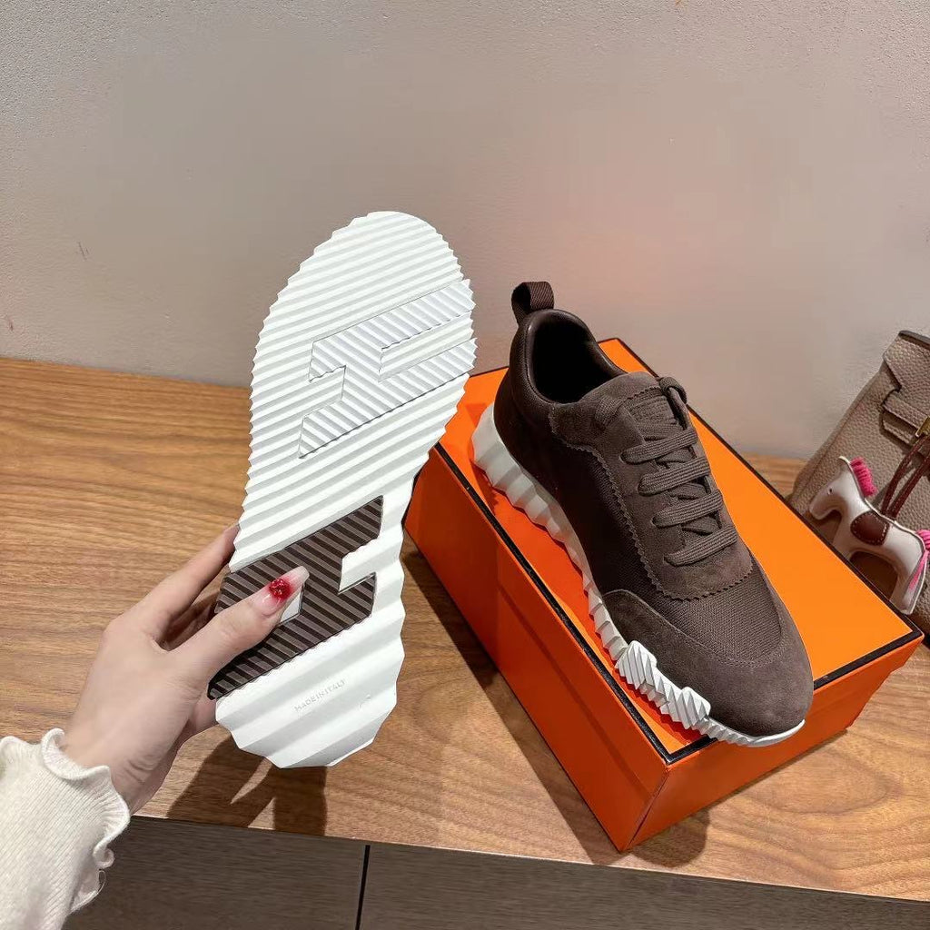 Grey suede sneaker with white treaded outsole and lace-up upper, Hermes