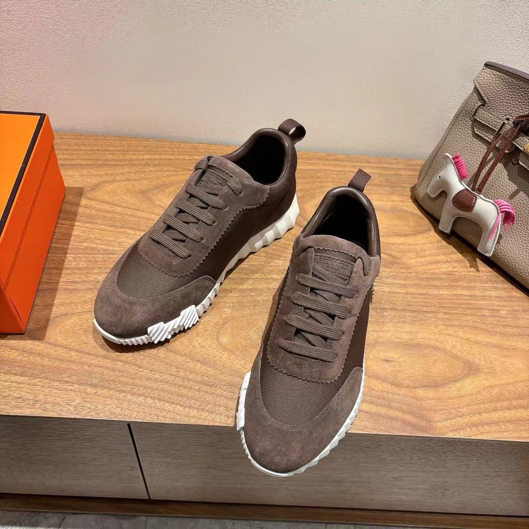 Grey suede lace-up sneakers, white textured sole and dark heel tab, Hermes