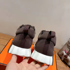 Grey suede sneakers held by heel, white ribbed platform sole, Hermes
