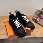 Hermes unisex sneakers, black with white laces and platform-style ribbed sole