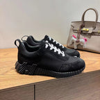 Hermes unisex sneakers, black with textured side panels and cushioned sole