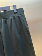 Louis Vuitton dark charcoal pants close-up of gathered front and pocket