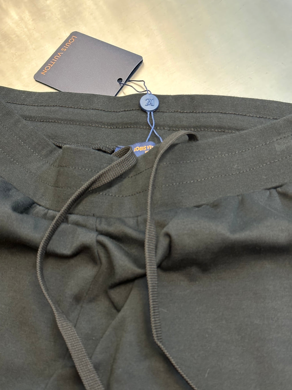 Louis Vuitton dark charcoal pants close-up of drawstring and zipper fly