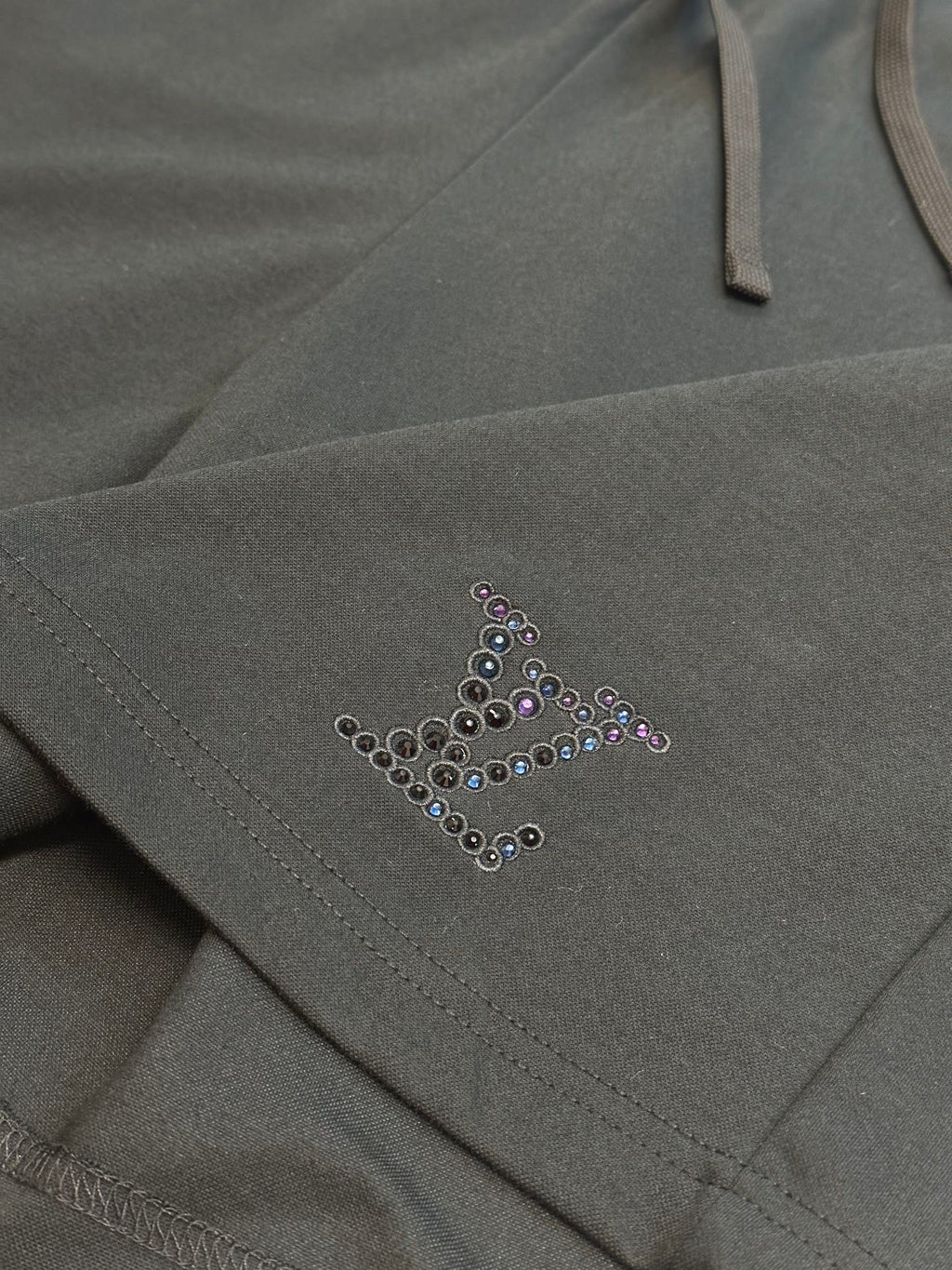 Louis Vuitton dark charcoal pants with beaded logo accent near pocket