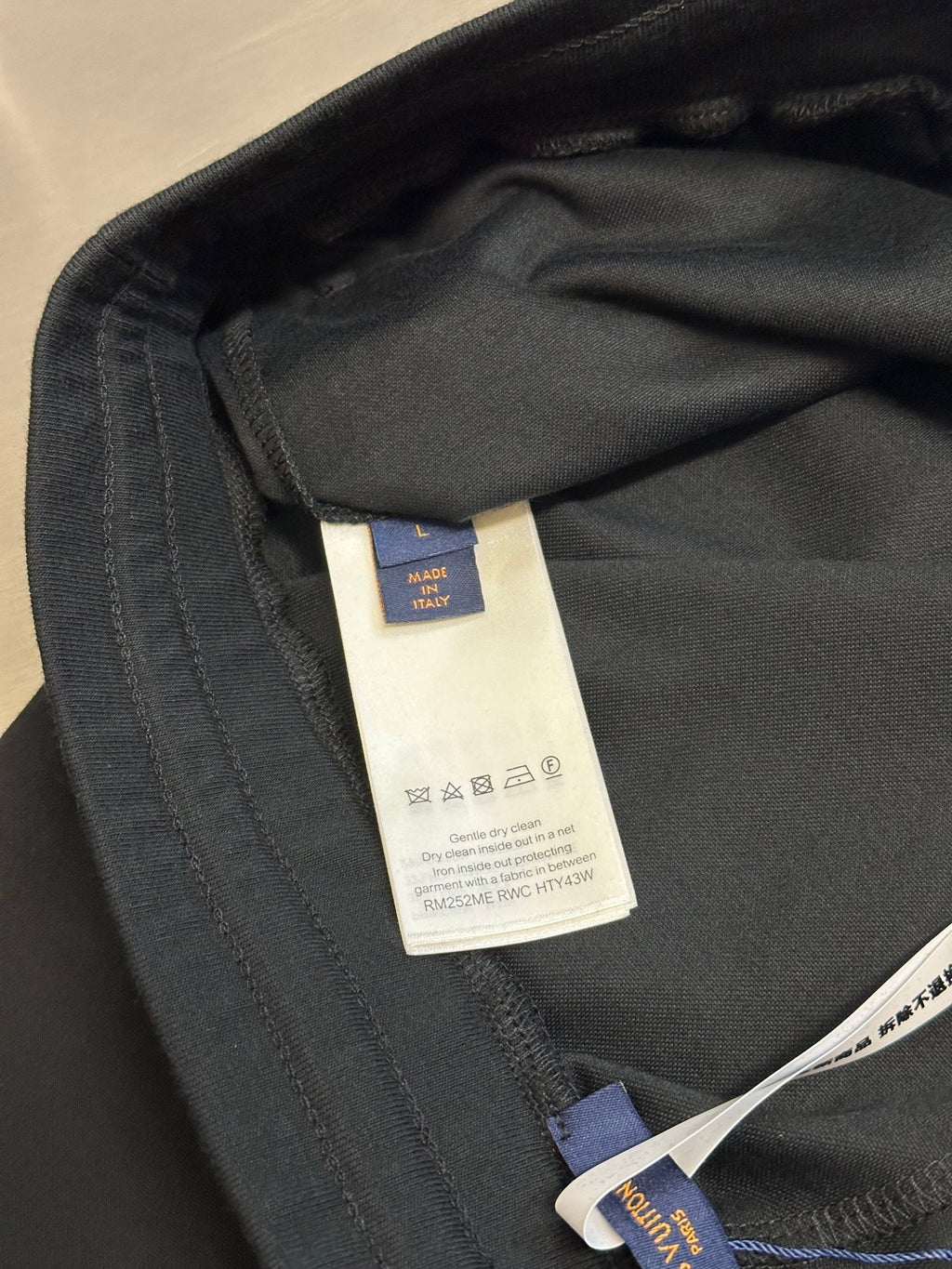 Louis Vuitton dark charcoal pants inner care label near waistband