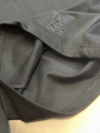 Louis Vuitton dark charcoal pants fabric close-up with beaded logo