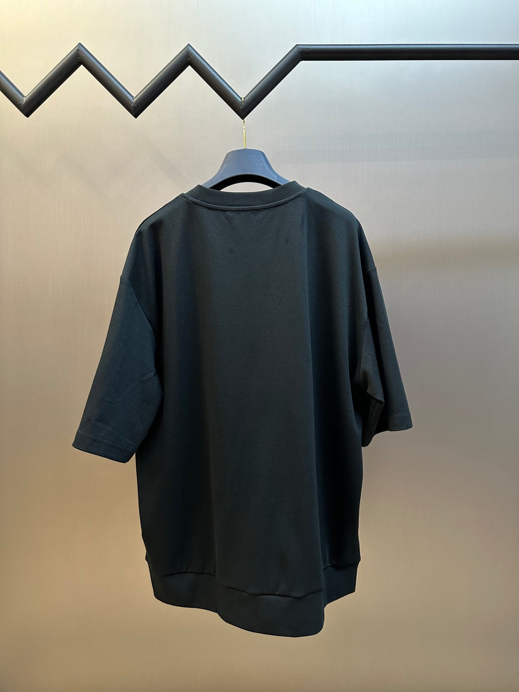 Dark charcoal short-sleeve sweatshirt back view on hanger
