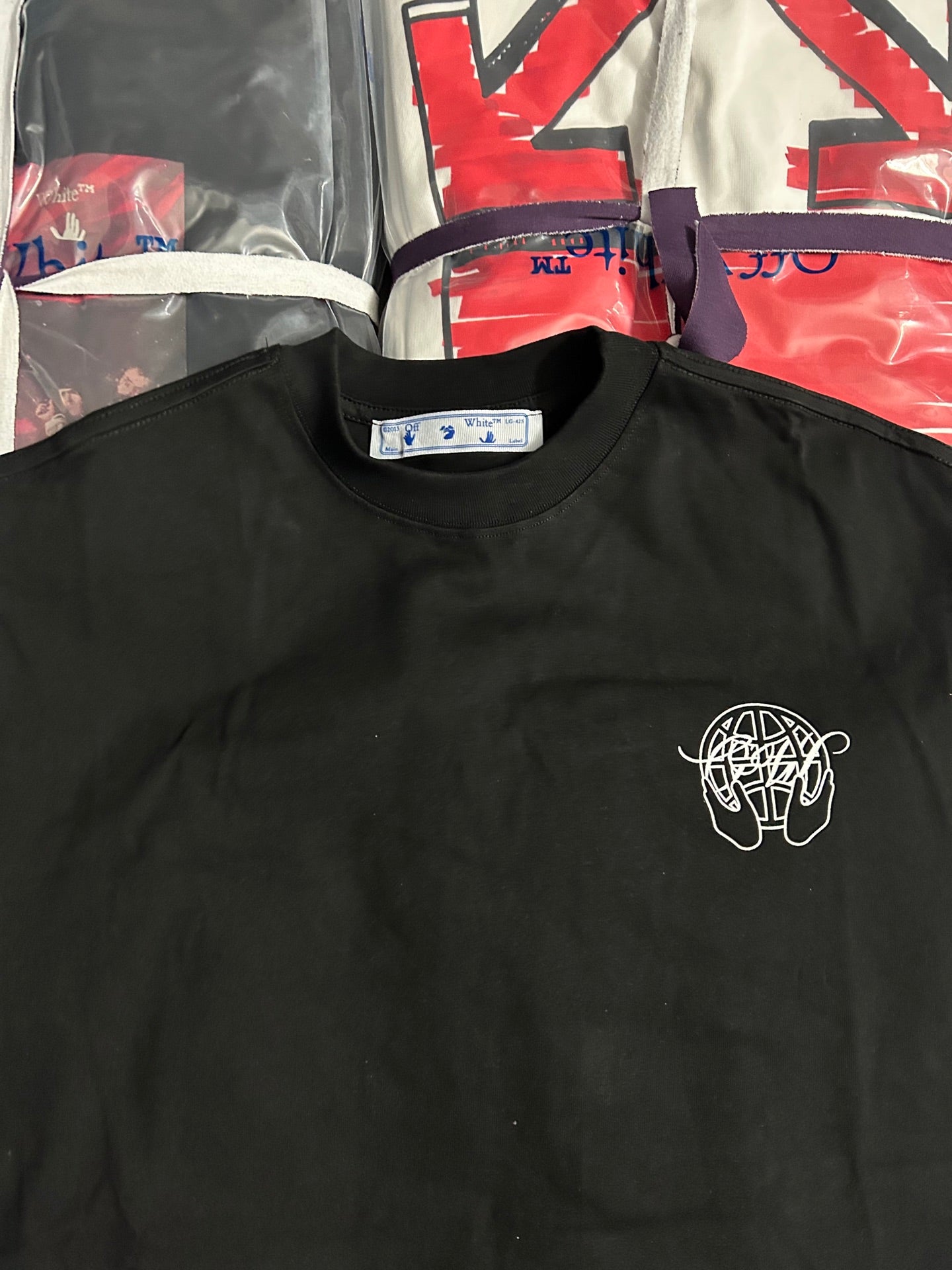 Off White black T-shirt close-up: crew neck and small white chest logo