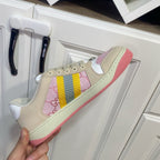 Unisex Gucci sneakers, cream with pink logo panel and yellow-blue stripe; pink sole edge