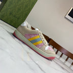 Unisex Gucci sneakers, cream upper with pink and yellow-blue stripe; red outsole