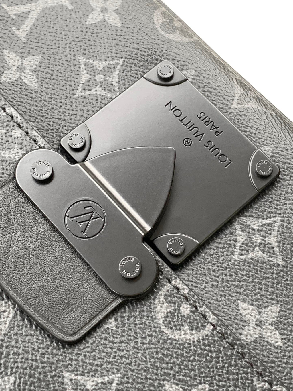 Men’s Louis Vuitton bag leather hardware plate on textured monogram fabric
