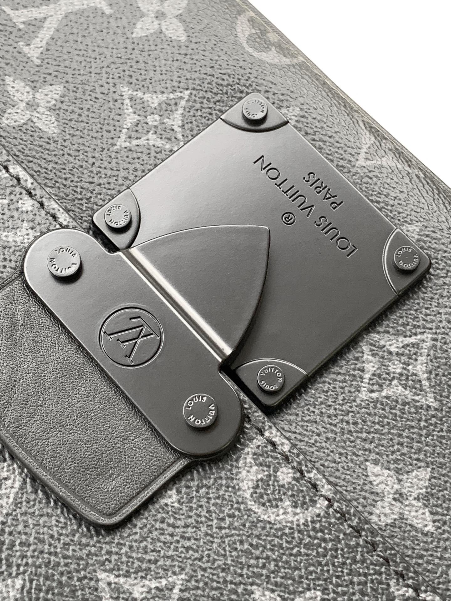 Men’s Louis Vuitton bag leather hardware plate on textured monogram fabric