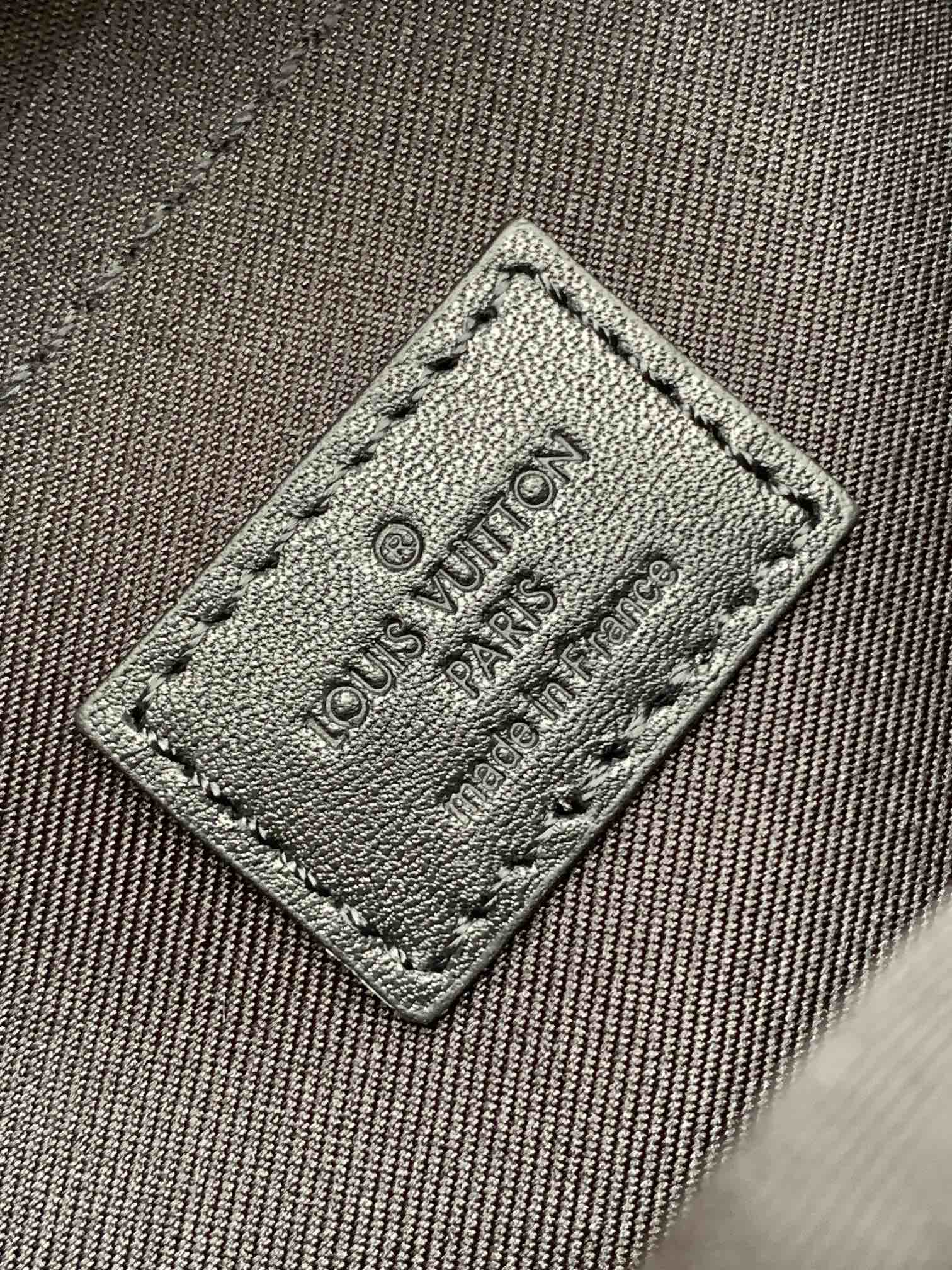 Men’s Louis Vuitton bag close-up of fabric logo label patch