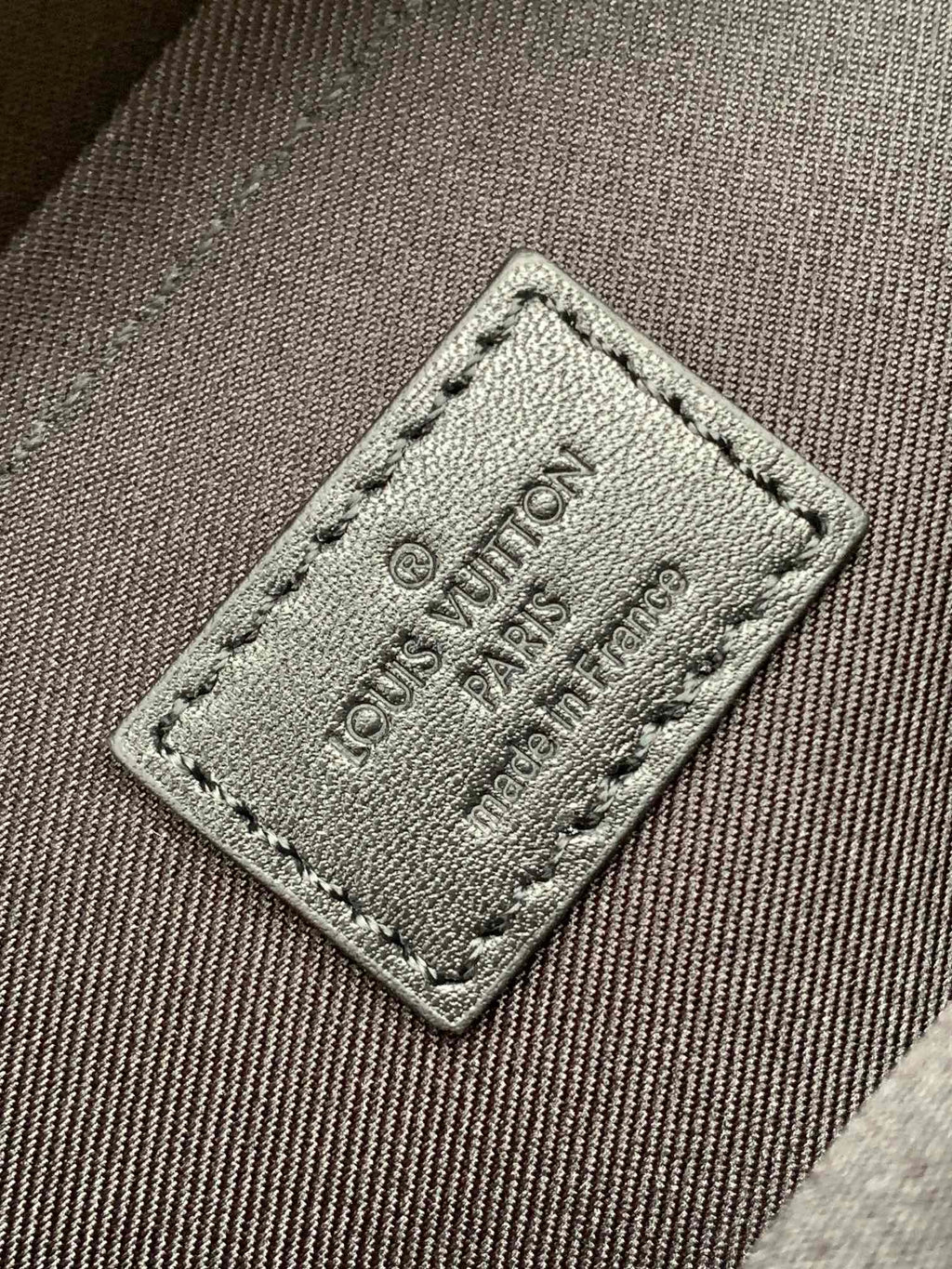 Men's Louis Vuitton monogram bag fabric tag with engraved Louis Vuitton Paris 18.8