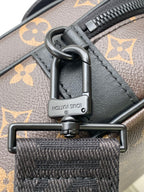 Men's Louis Vuitton monogram bag hardware closeup with engraved push-lock