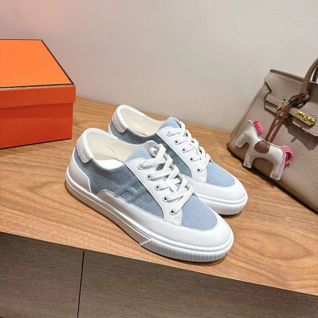 White and light-blue lace-up sneakers with thick white midsole and cupsole.