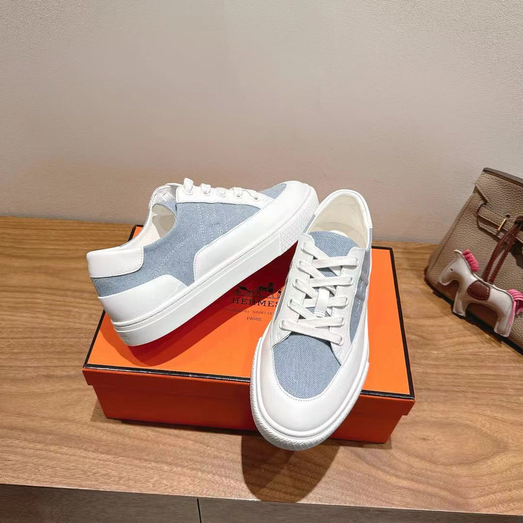 White and light-blue lace-up sneakers, rear and side quarter view.
