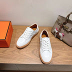 White leather lace-up sneakers with gum rubber sole, side profile