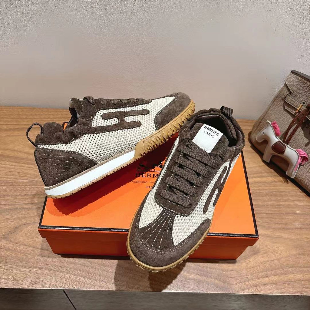 Lace-up low-top sneakers with white side stripe, dark gray panels, and tan gum outsole.
