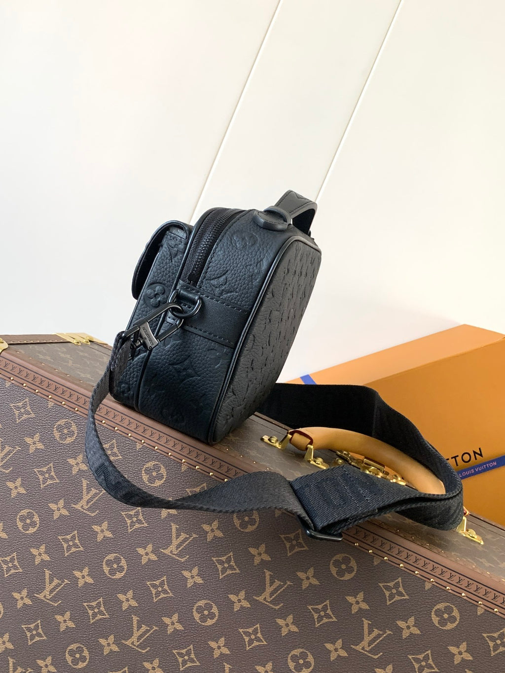 Men’s Louis Vuitton monogram crossbody bag in dark navy, side view with zipper