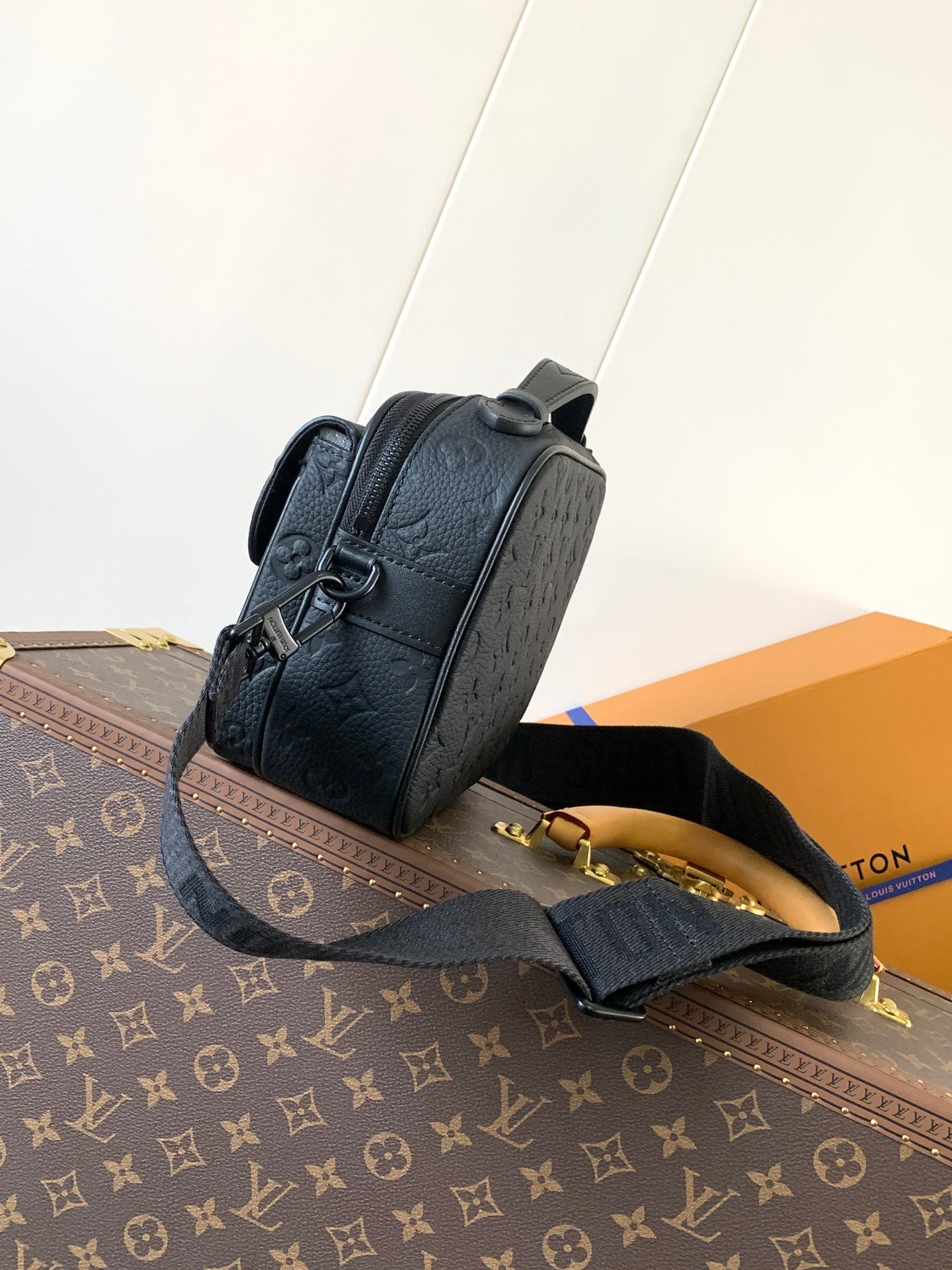 Men’s Louis Vuitton monogram crossbody bag in dark navy, side view with zipper