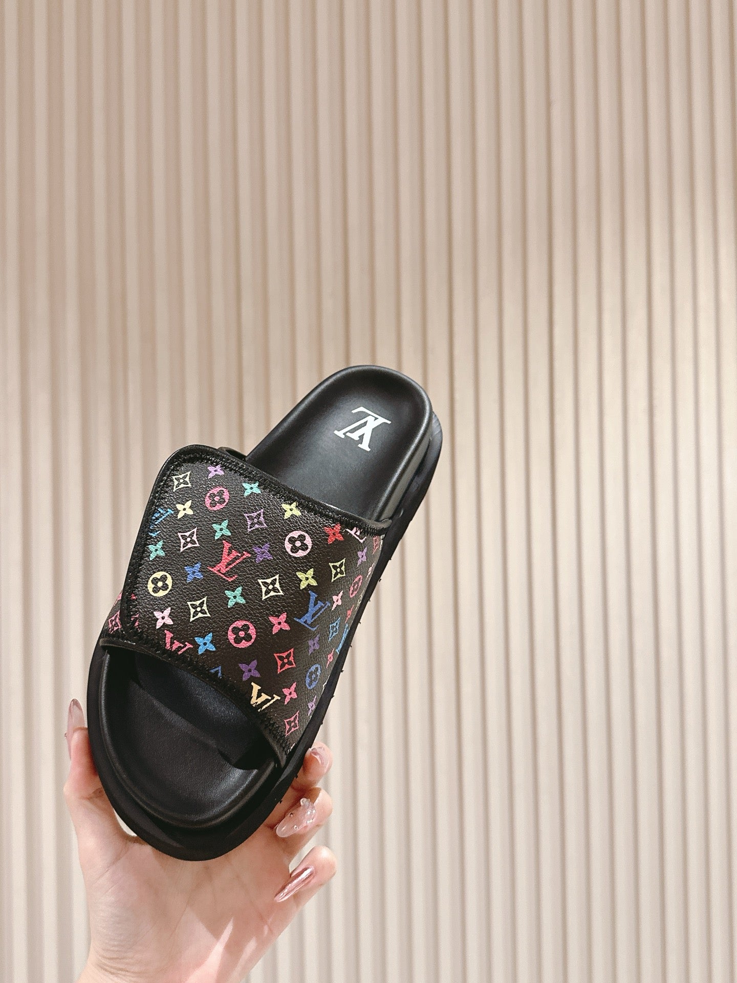 Louis Vuitton slide sandals, front view with black strap and multicolor monogram pattern