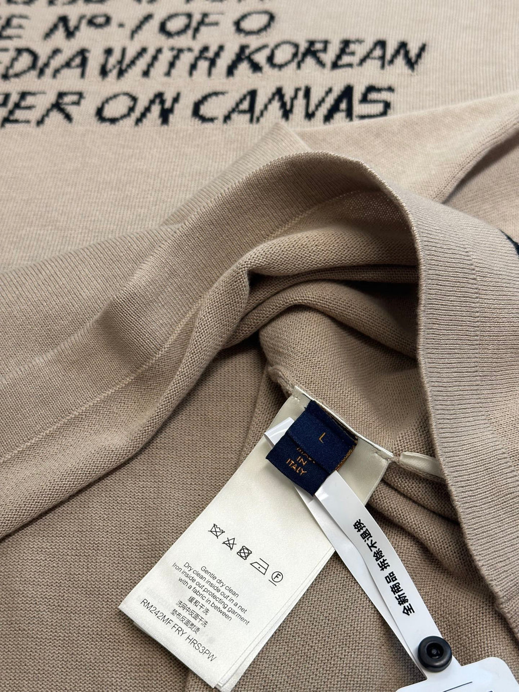 Light beige T-shirt fabric fold with white care tag and blue brand hangtag