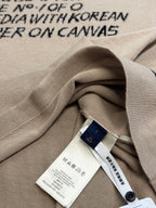 Light beige T-shirt fabric fold with white care tag and blue brand hangtag