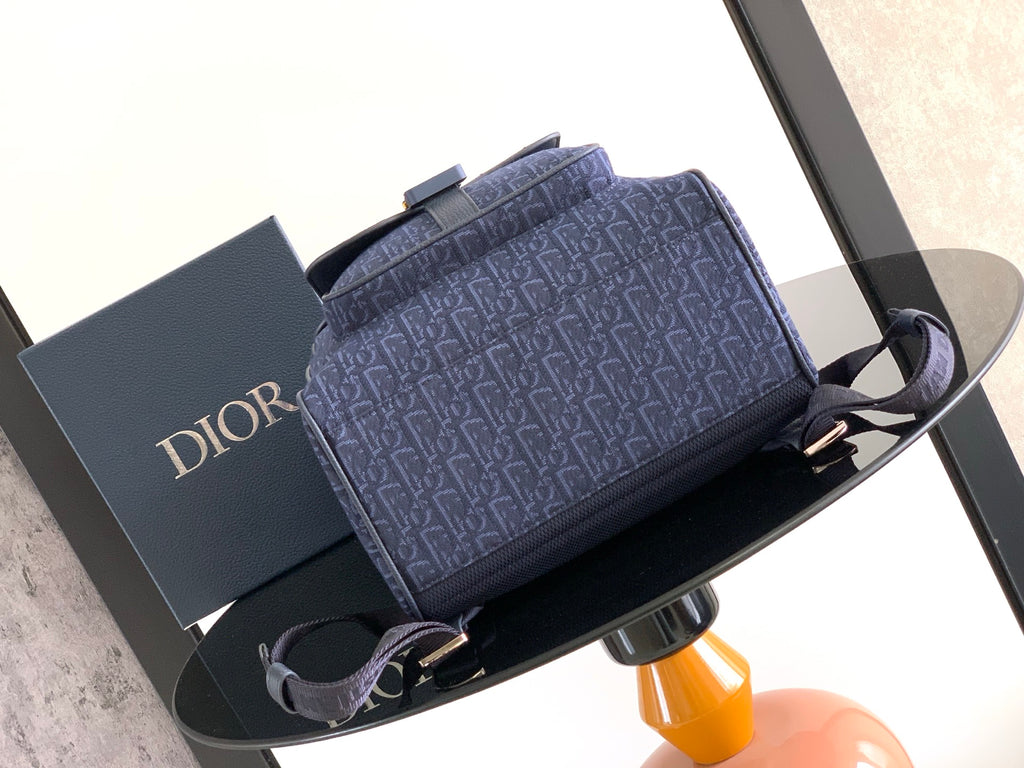 Men's Dior small backpack in blue monogram with gray top handle and straps