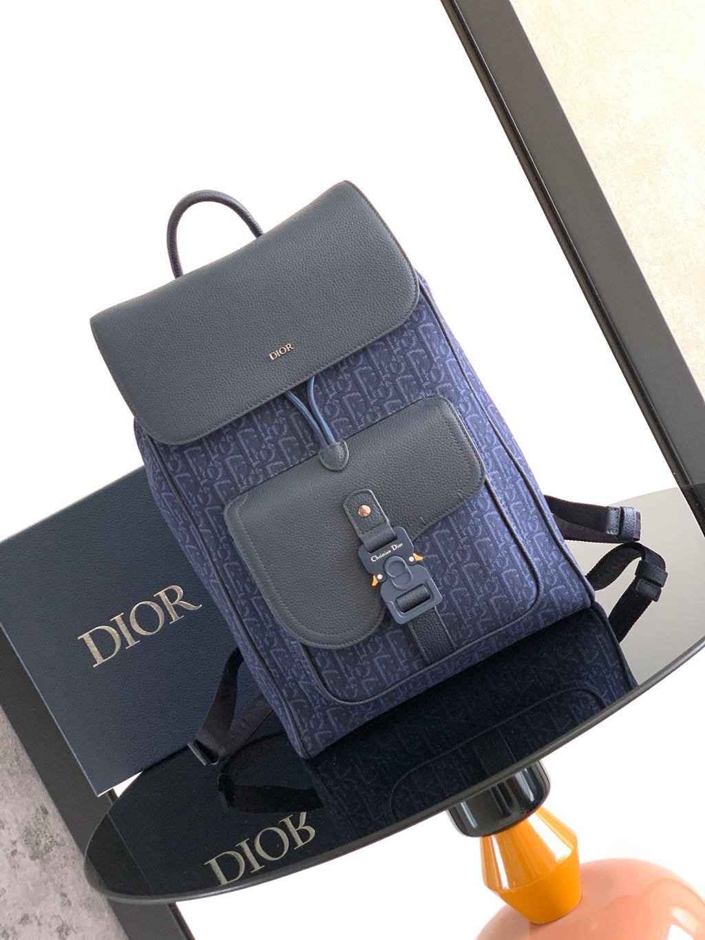 Dior bag with blue monogram fabric and gray flap front, top handle and strap