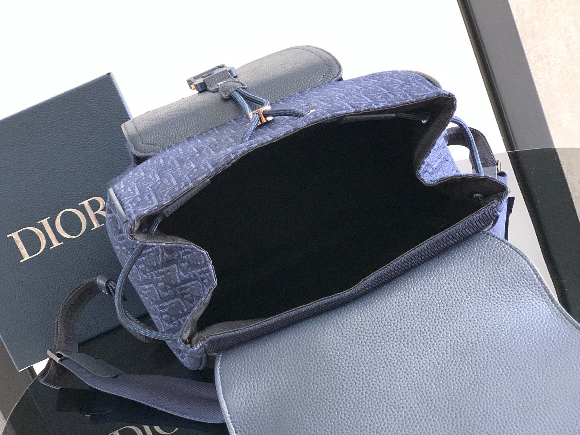 Men's Dior mini bag open top showing black interior lining