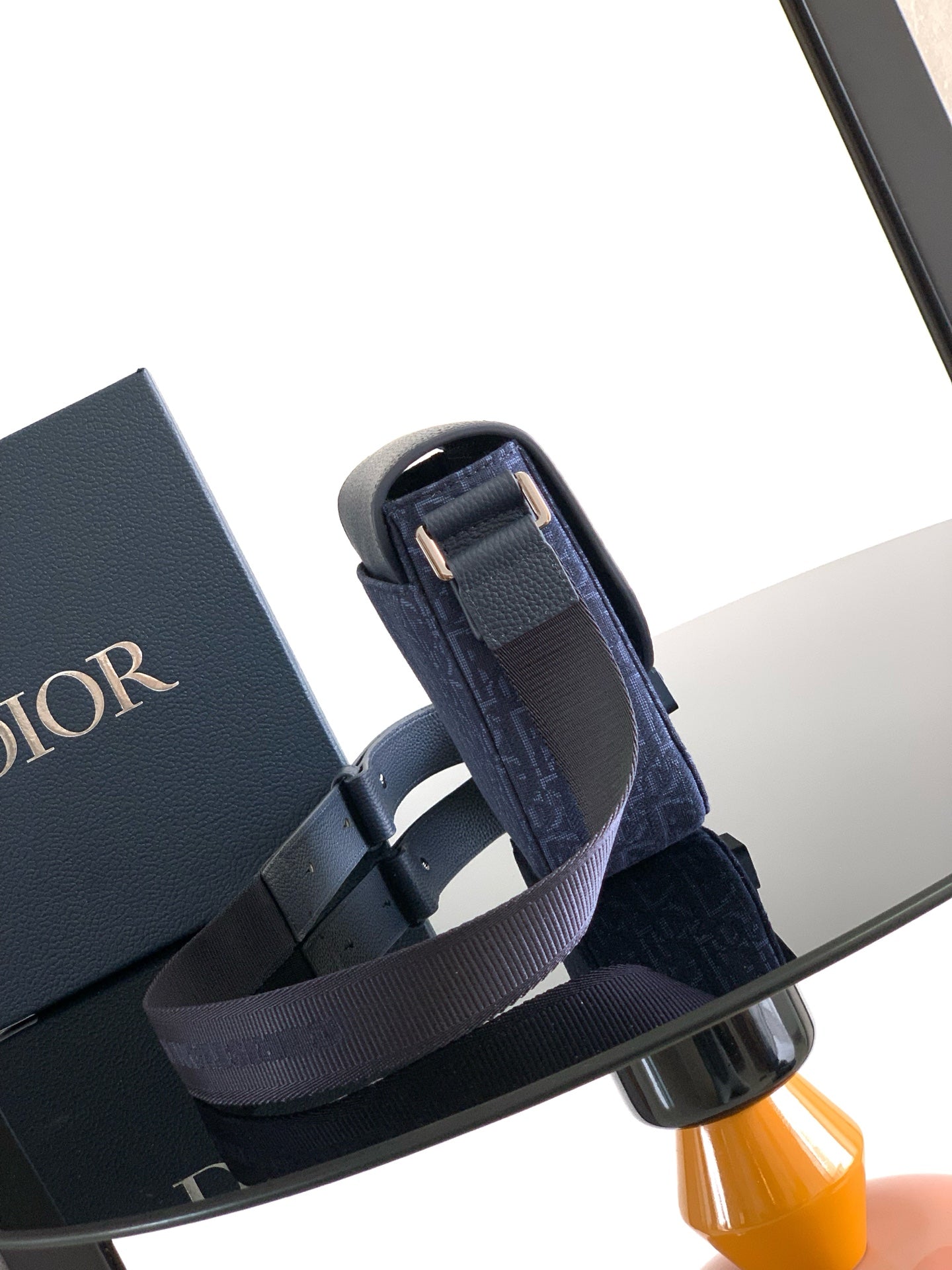 Dior bag on strap base, navy blue logo canvas with leather buckle detail