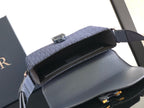 Dior bag interior view, open top with navy flap and adjustable shoulder strap