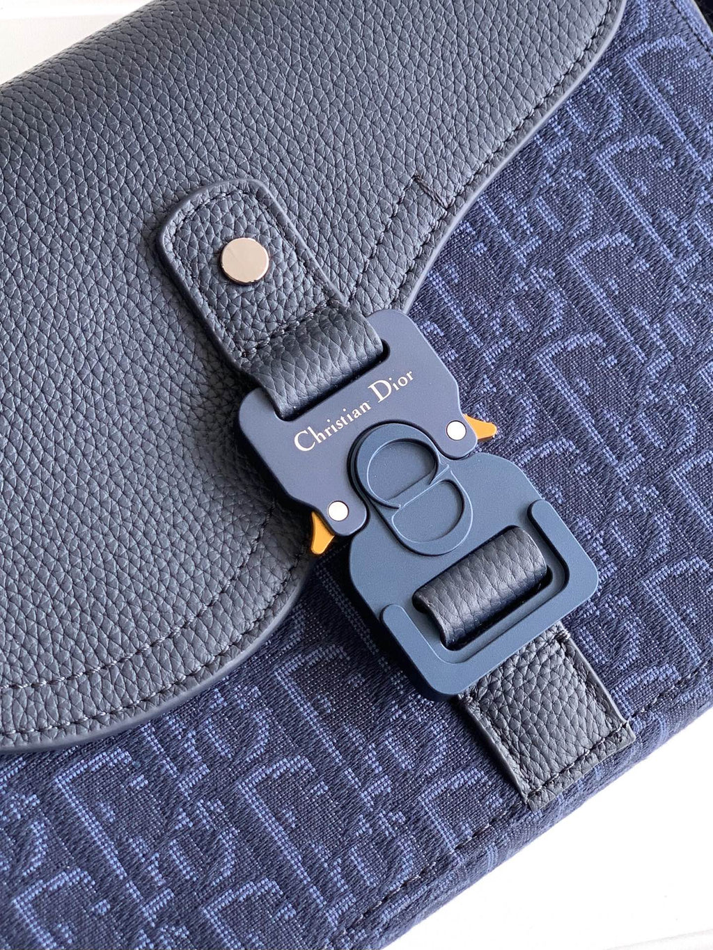 Dior bag close-up of hardware, navy textured leather with monogram fabric