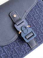 Dior bag close-up of hardware, navy textured leather with monogram fabric