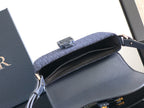 Navy Dior bag open-top view with interior lining and front flap hardware.
