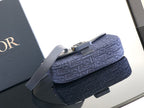 Navy Dior mini crossbody bag with textured logo fabric and top handle strap.
