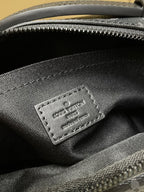 Louis Vuitton monogram bag inner label stitched on dark fabric near zipper