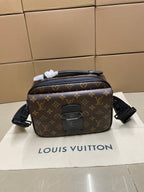 Louis Vuitton monogram crossbody bag with black leather trim and front zip pocket