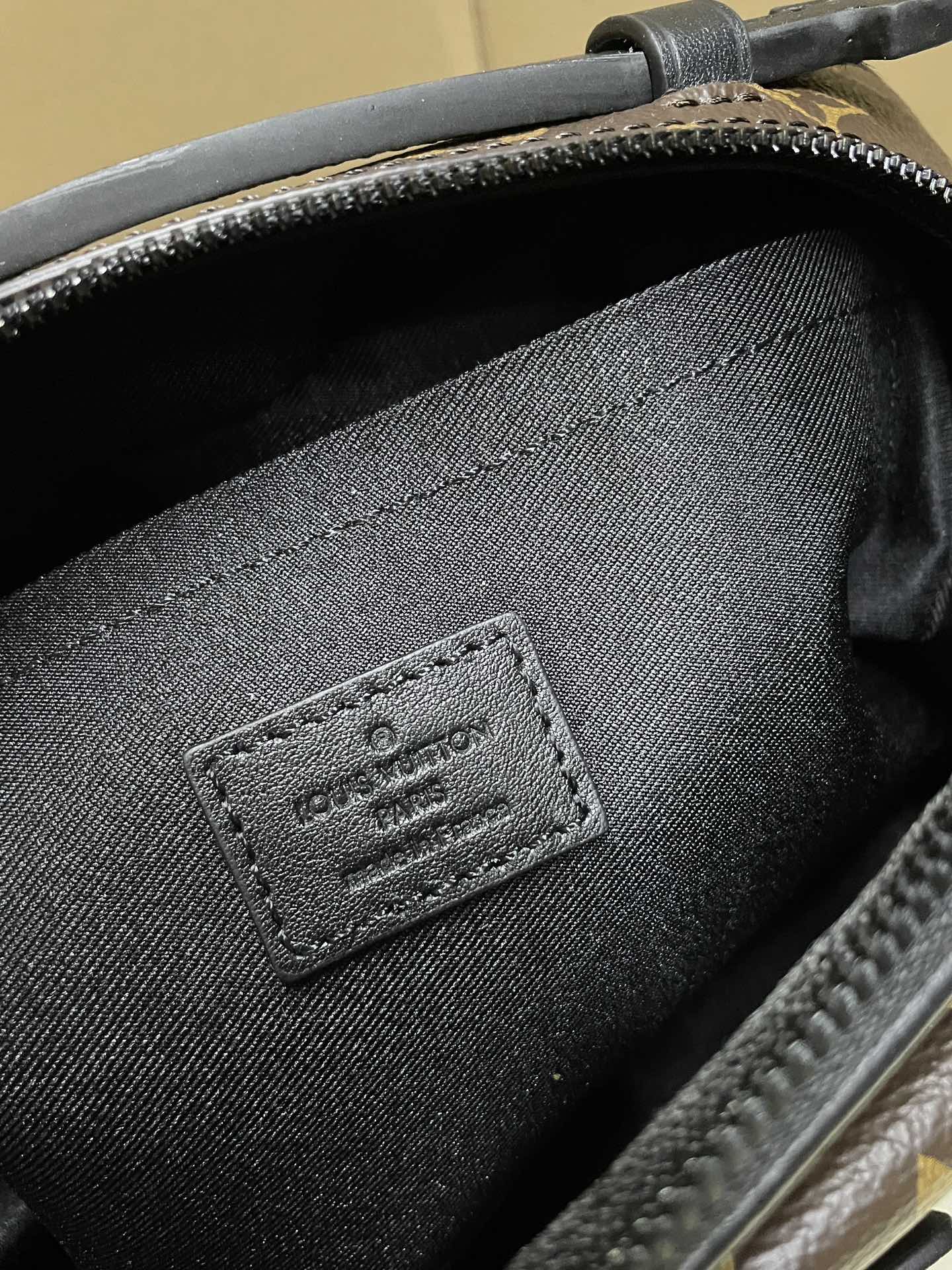 Louis Vuitton crossbody bag interior close-up with leather patch and stitching