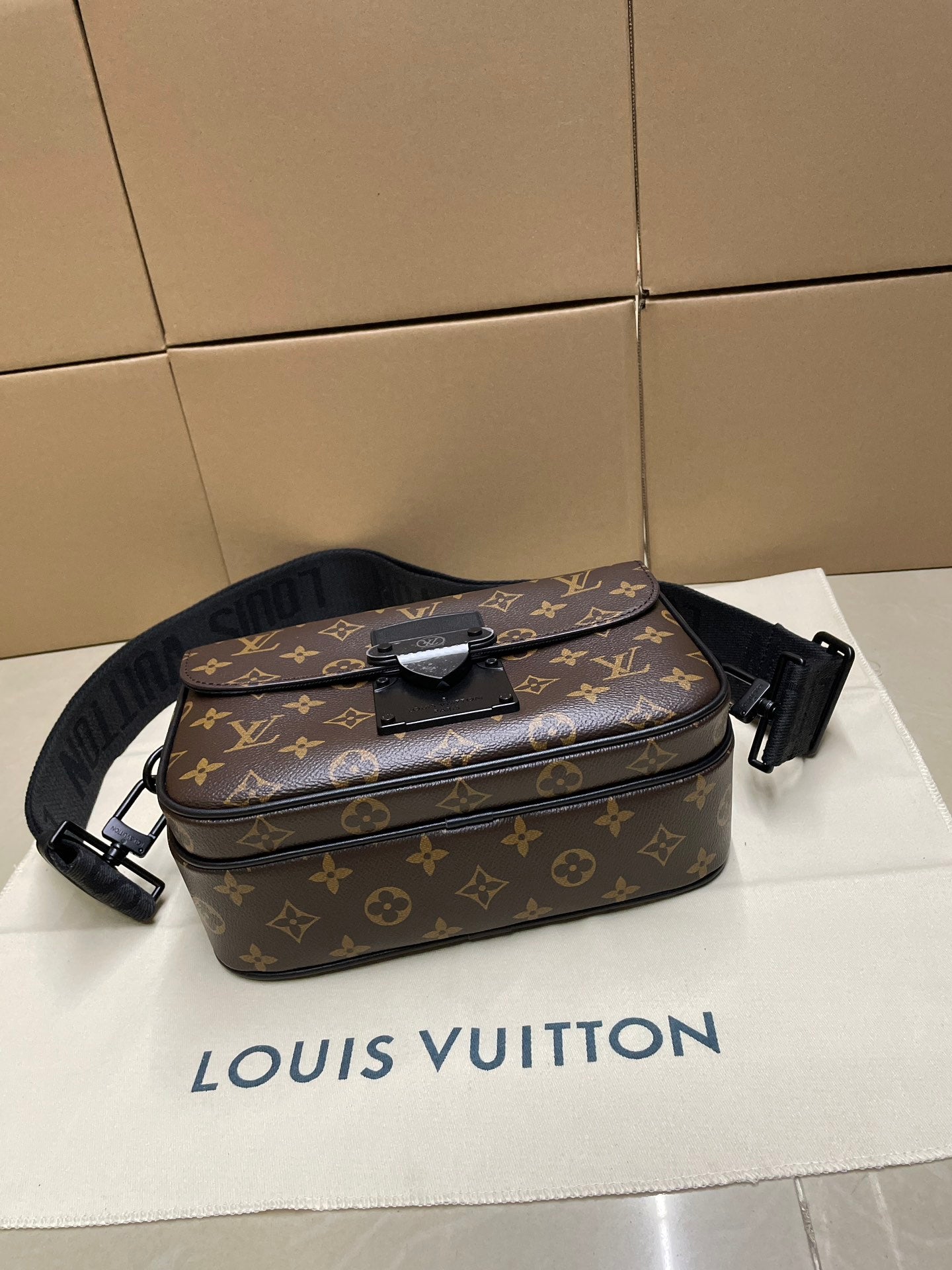 Louis Vuitton monogram crossbody bag with front bow detail and adjustable shoulder strap