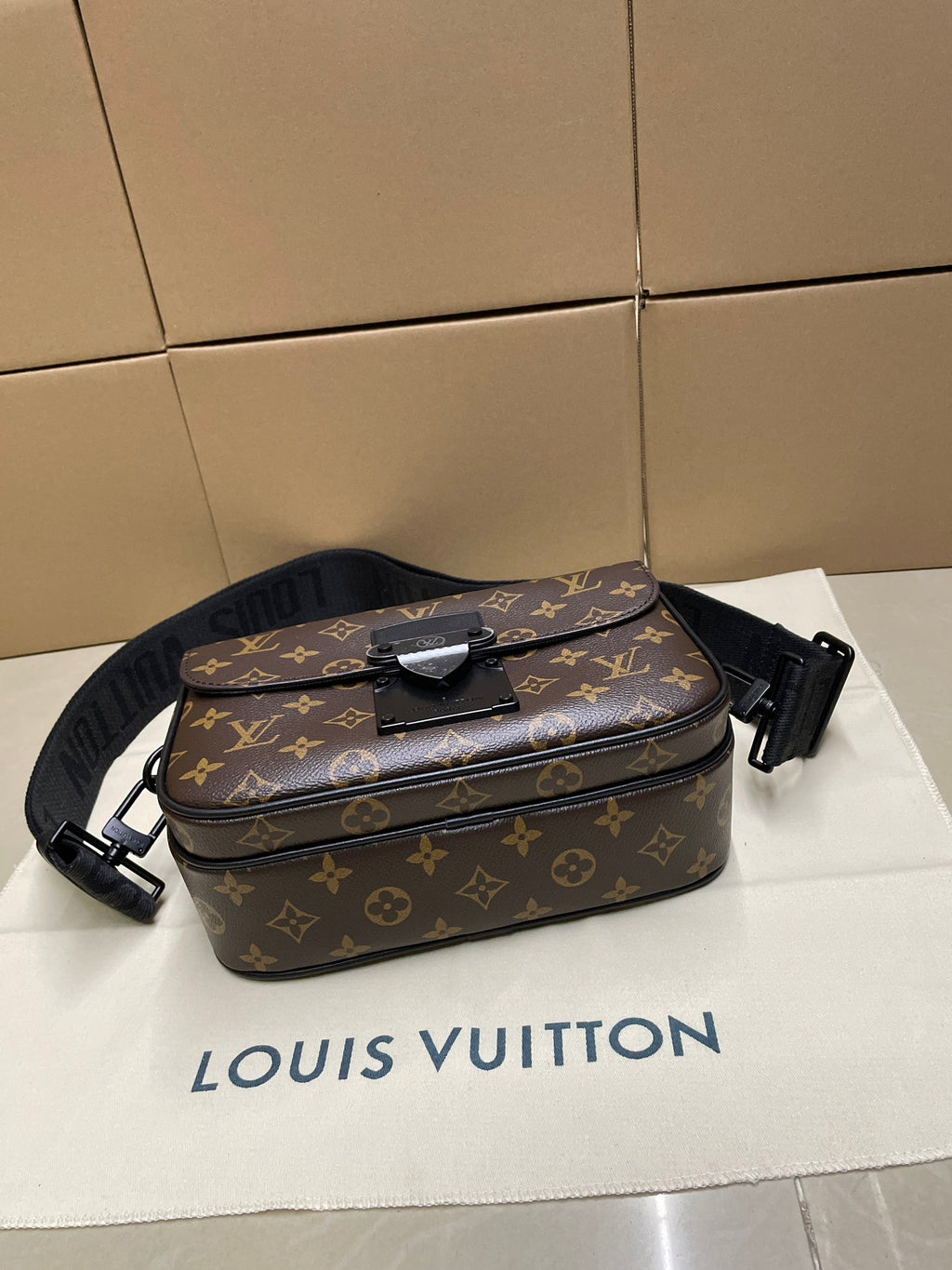 Louis Vuitton monogram crossbody bag with top handle, zip closure, adjustable strap