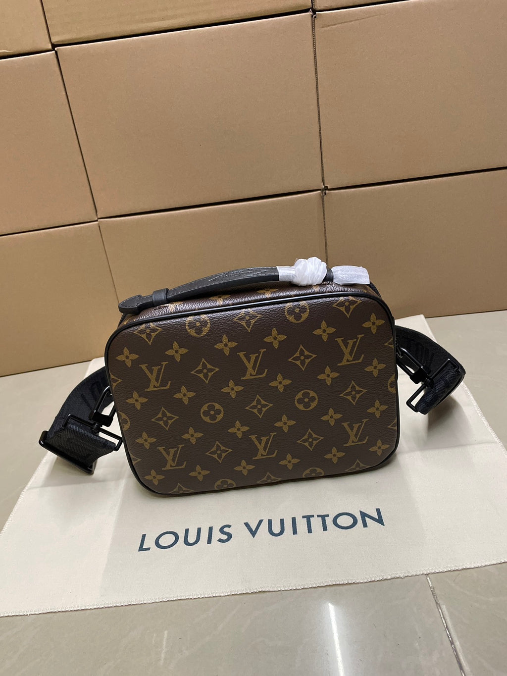 Louis Vuitton monogram crossbody bag viewed from side with adjustable shoulder strap