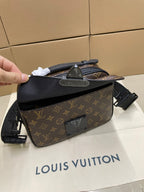 Louis Vuitton monogram crossbody bag held up by strap, zip top and front hardware